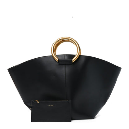 Black maxi trapezoid tote with gold ring handle and small front zip pouch