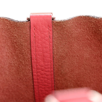 Pink leather strap with metal buckle clasp at the tote edge
