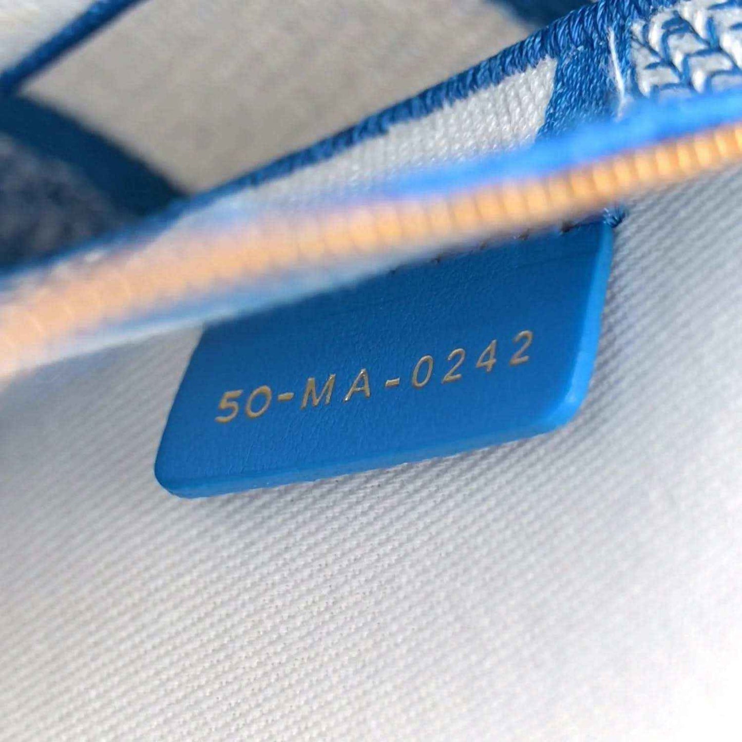 Blue serial code tag inside the bag reading 50-MA-0242.