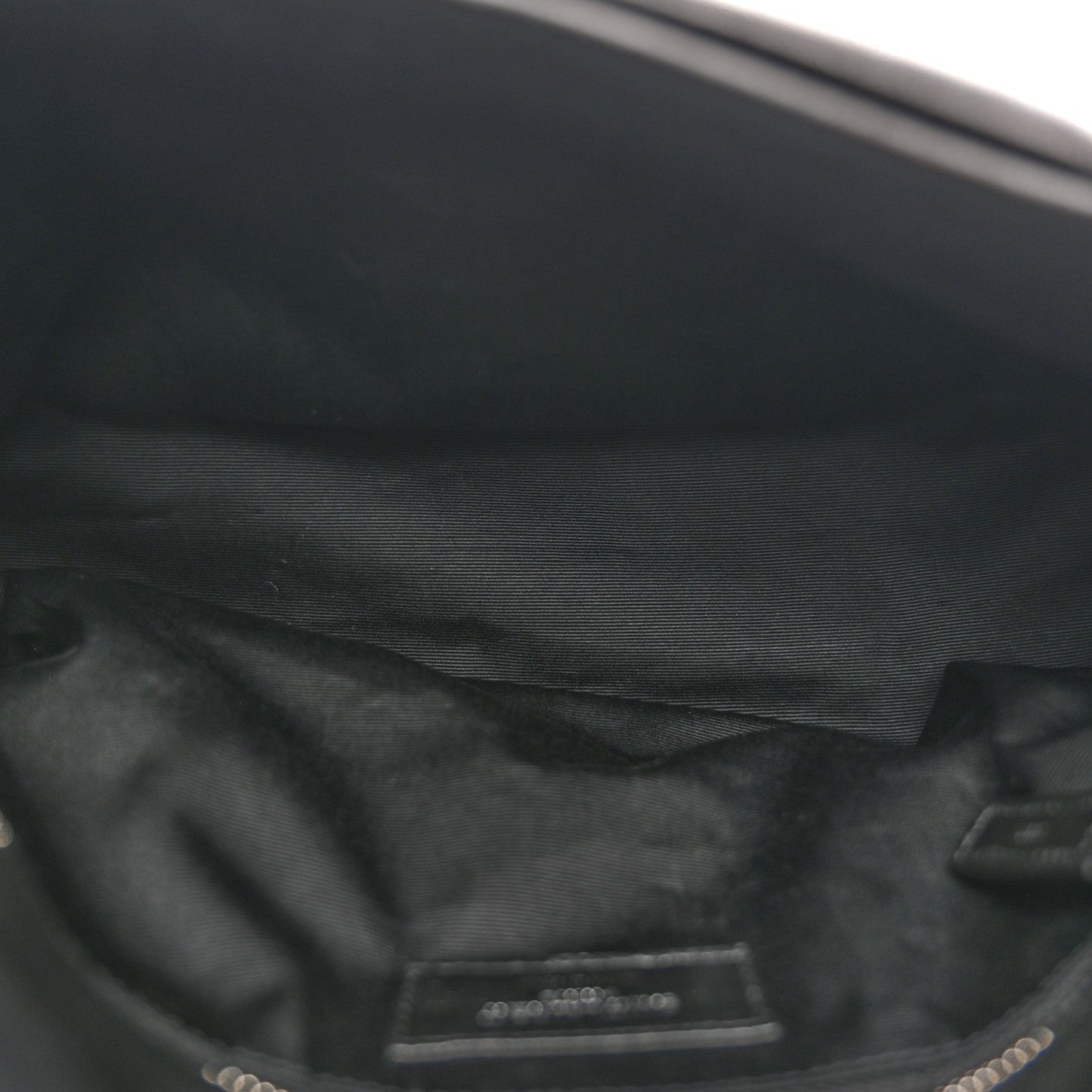 Black leather satchel interior lining with stitched pocket