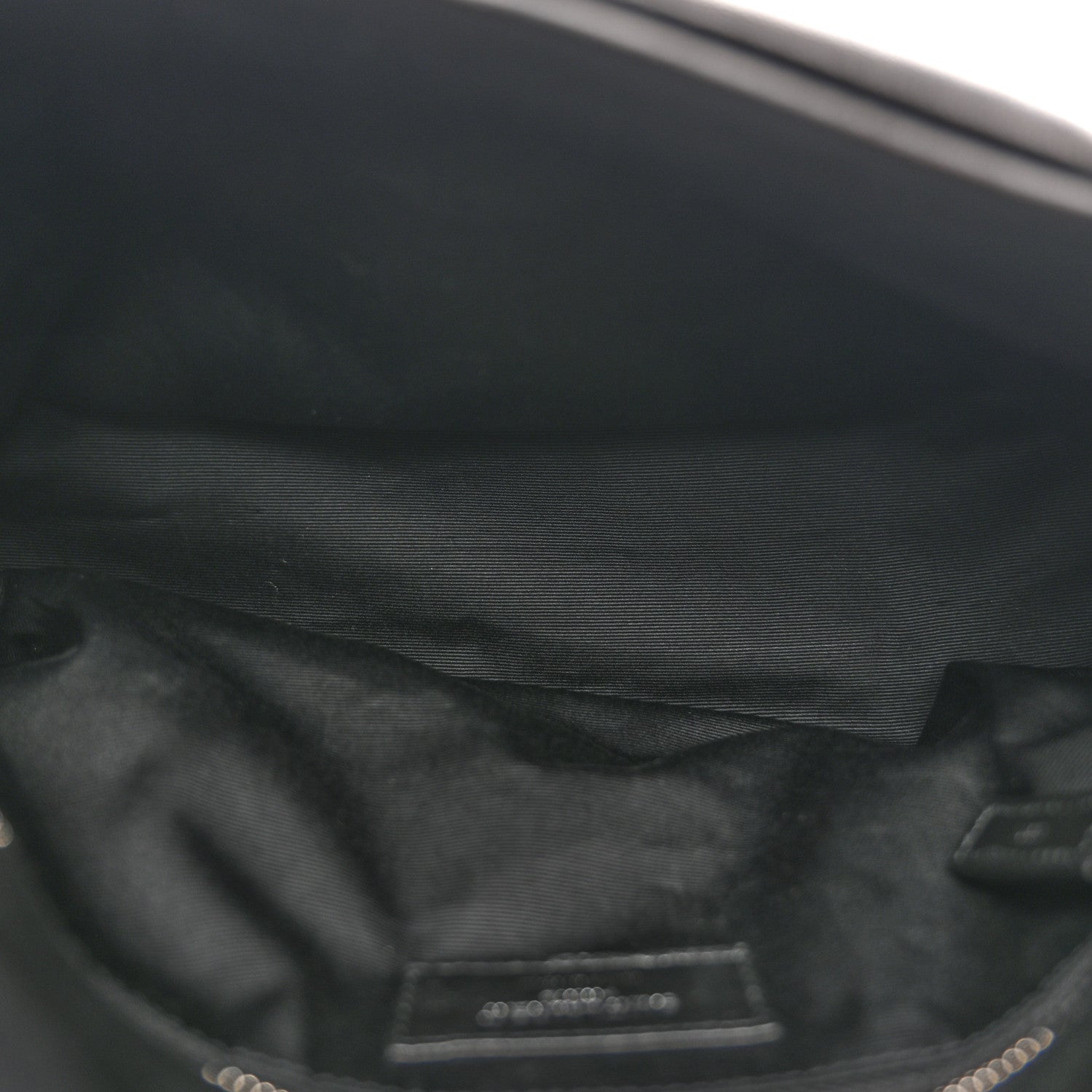 Black leather satchel interior lining with stitched pocket