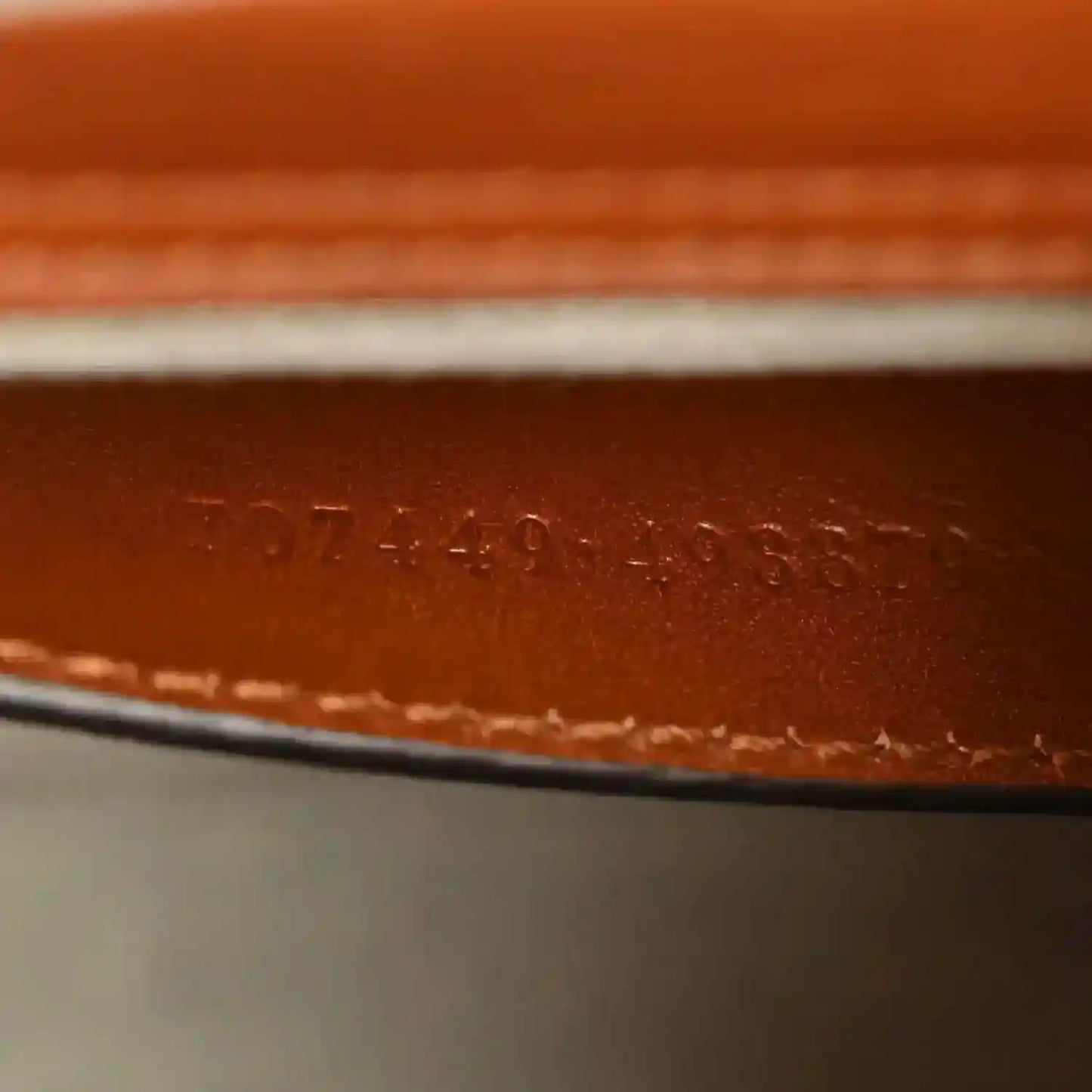 Gucci mini tote bag leather base with stamped serial or style number.