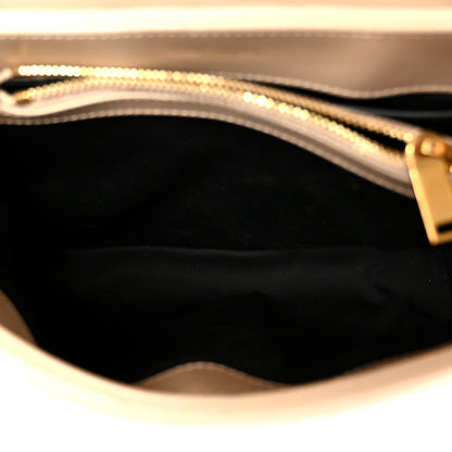 Dark beige leather satchel interior with zipper opening and gold chain trim