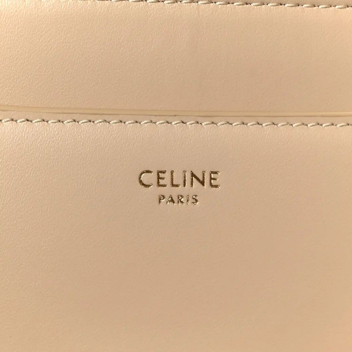 Celine Paris logo stamped on beige leather panel with stitching