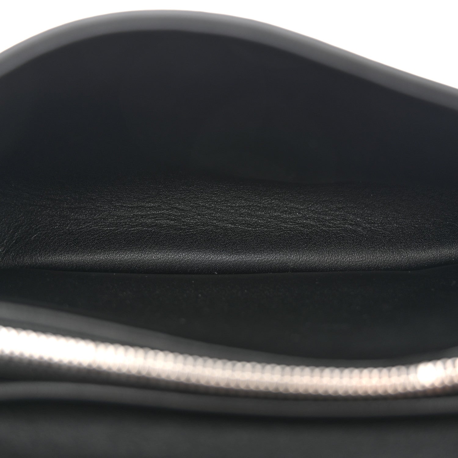 Black leather shoulder bag close-up of smooth top edge and inner lining