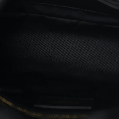 Saint Laurent satchel interior close-up with dark lining and gold-tone zipper