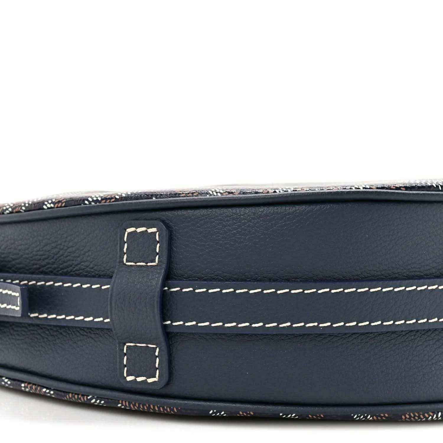 Navy leather strap mount with contrast stitching and buckle, close-up