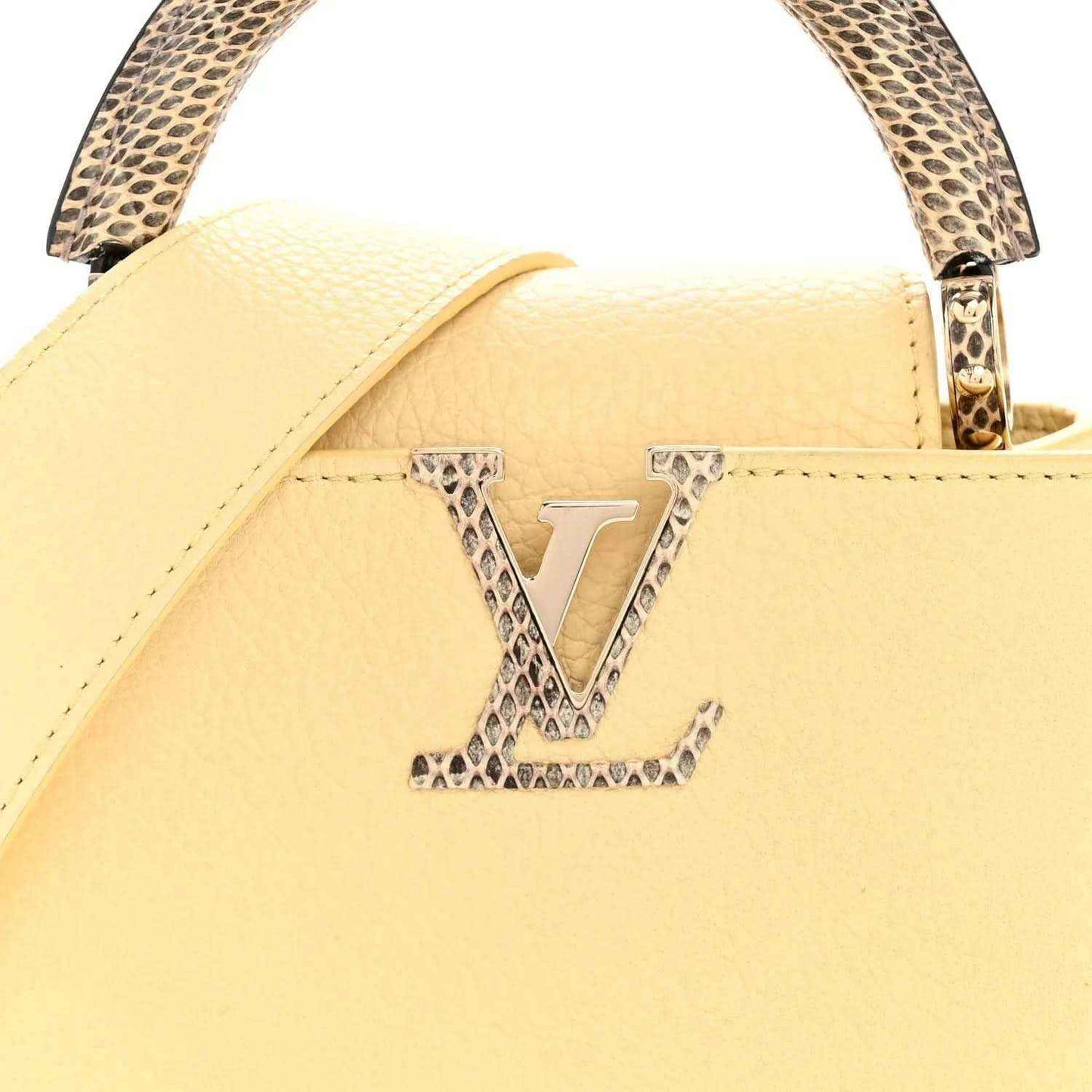 Cream mini handbag front with snakeskin handle trim and gold LV-style emblem.