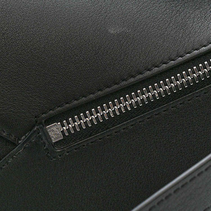 Small Puzzle Edge shoulder bag, black calfskin leather close-up of metal zipper
