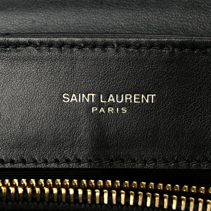 SAINT LAURENT PARIS text on black leather with gold zipper edge detail.