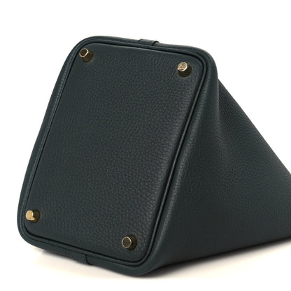 Dark green leather tote with gold-tone corner studs and front panel seam