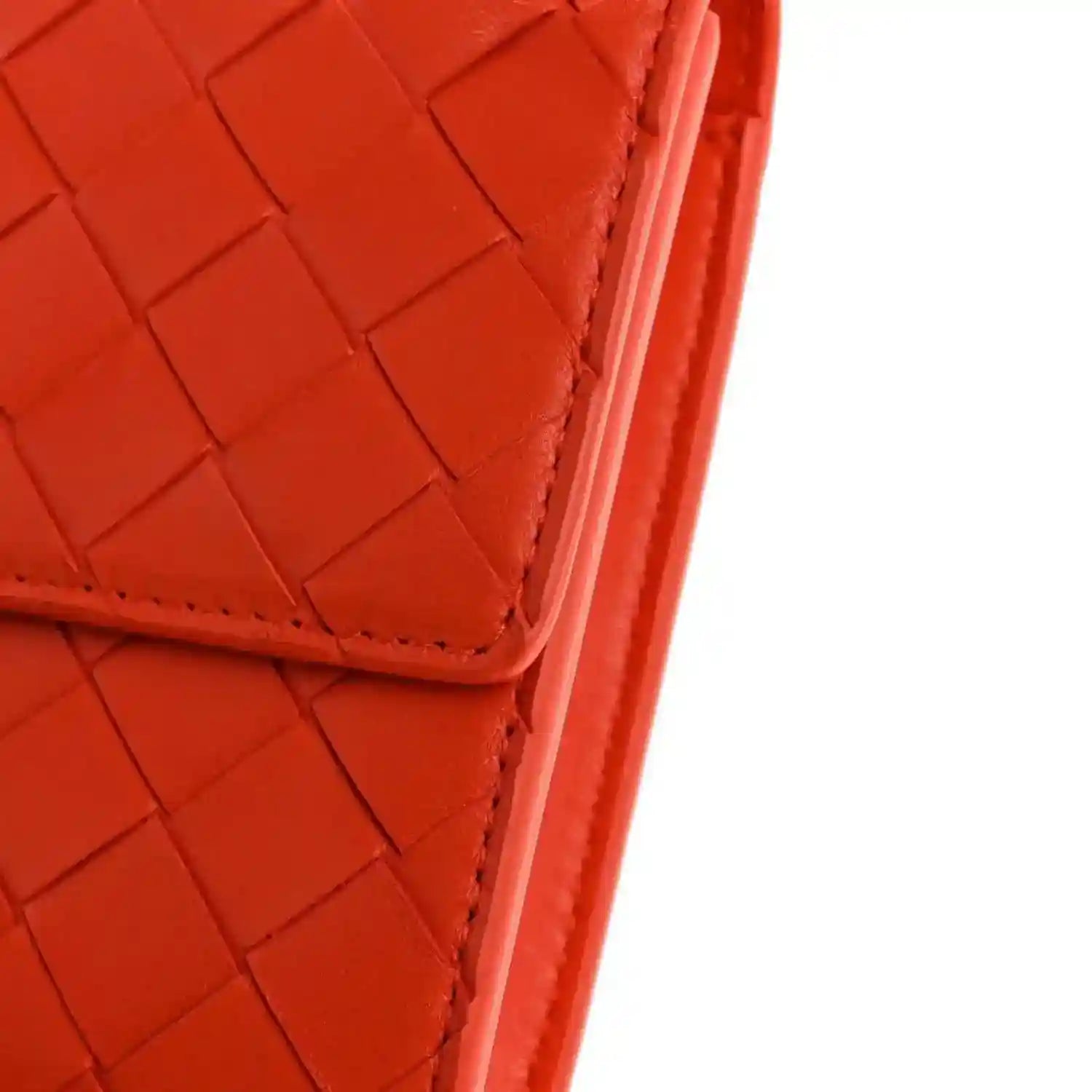 Orange intrecciato nappa clutch corner with stitched edge and structured seam