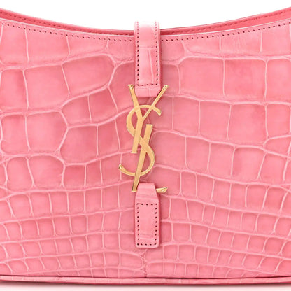 Pink alligator-textured hobo bag front with YSL monogram charm and vertical strap