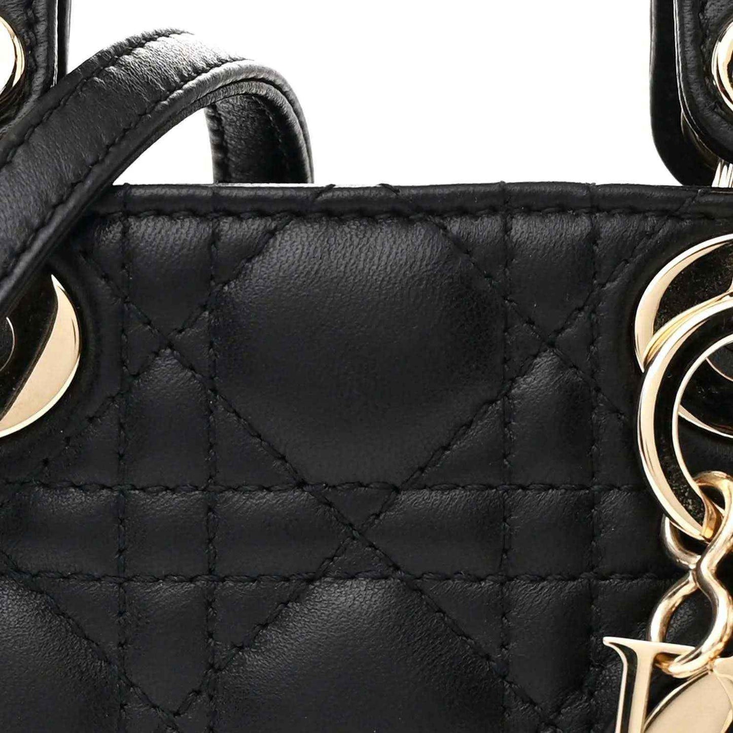 Black quilted handbag panel with gold-tone chain link charm and stitching