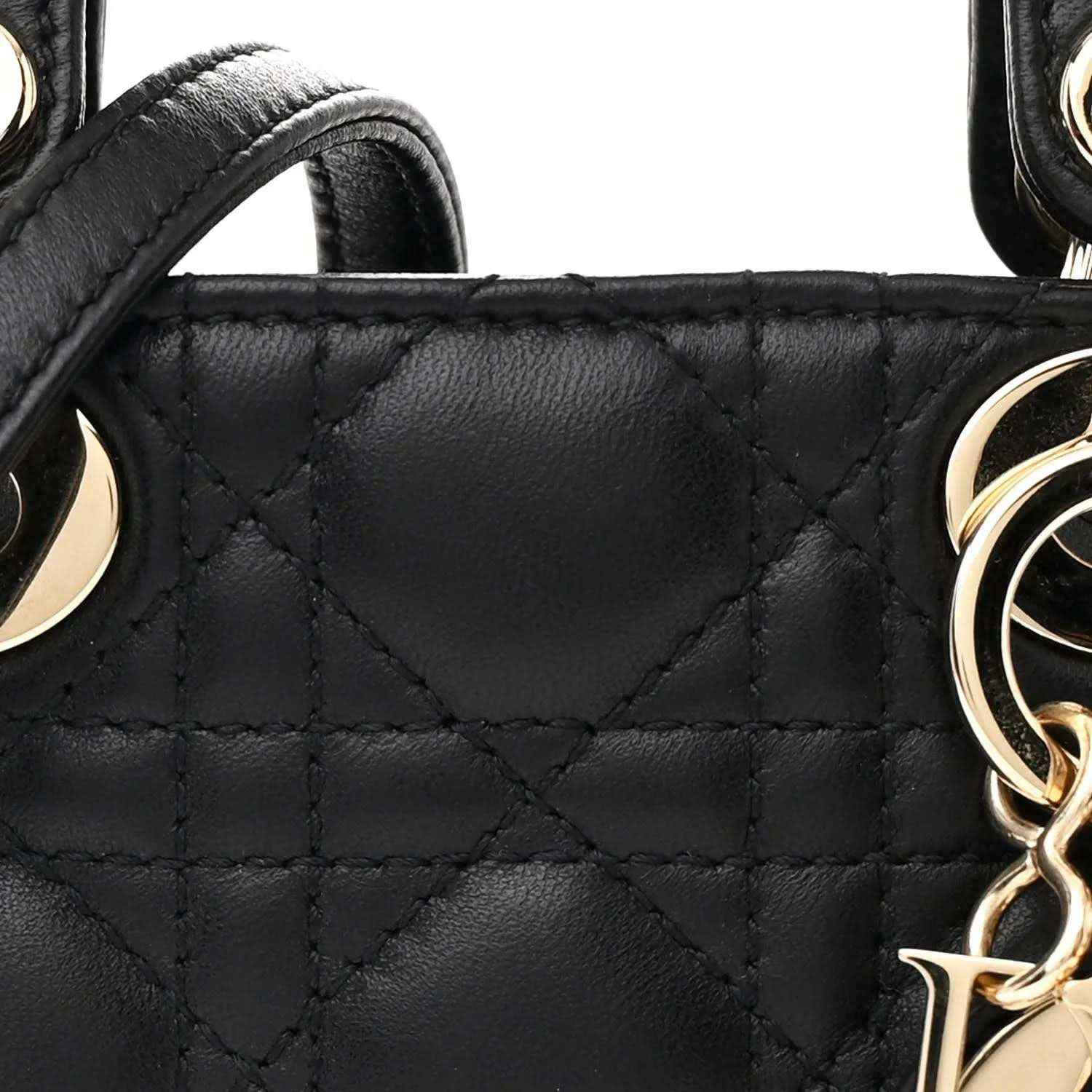 Black quilted handbag panel with gold-tone chain link charm and stitching