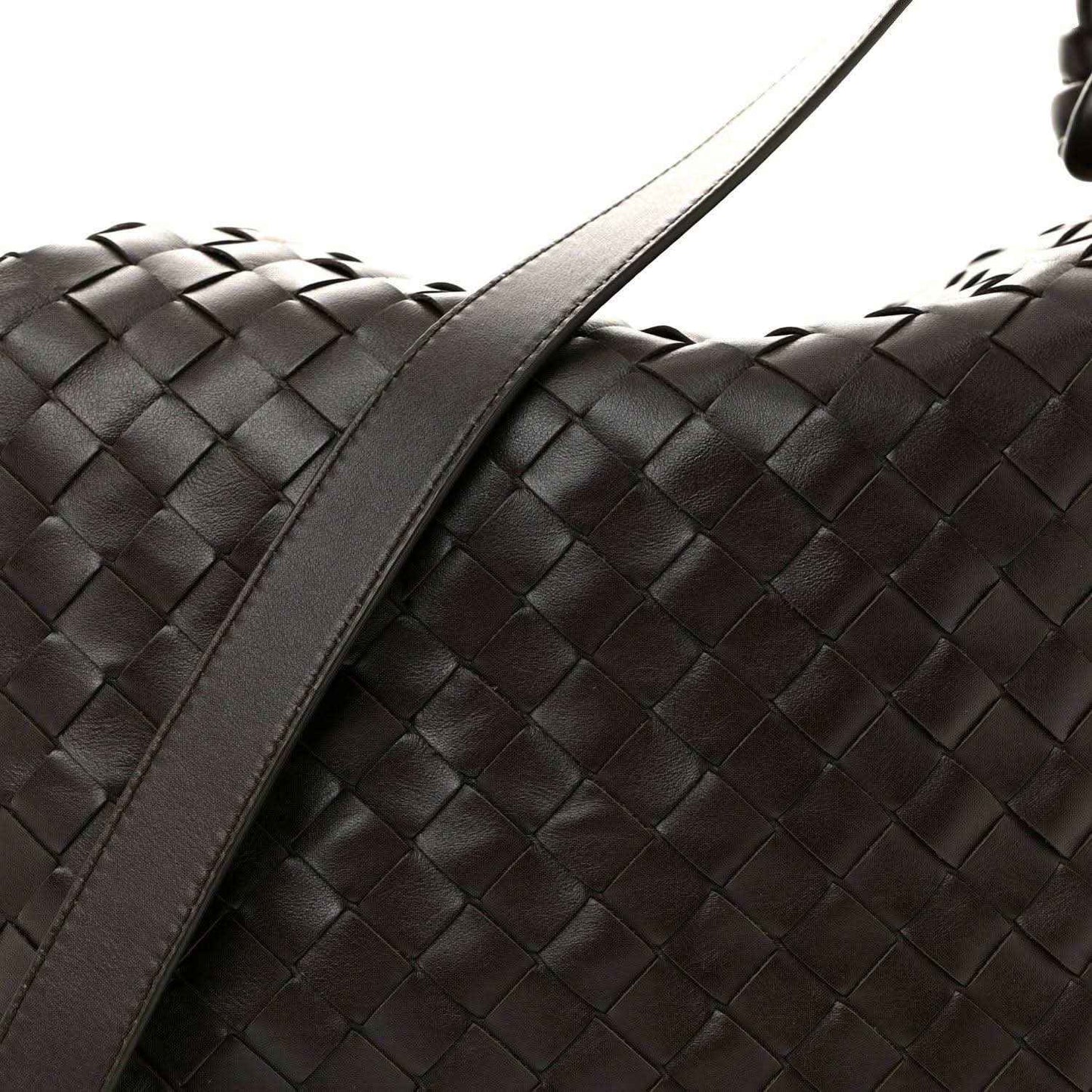 Black woven leather weekender bag side with wide strap and braided pattern