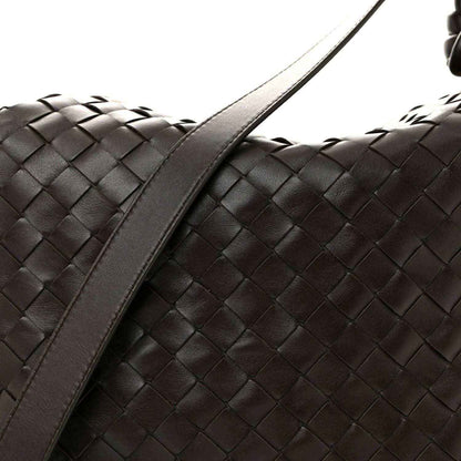 Black woven leather weekender bag side with wide strap and braided pattern
