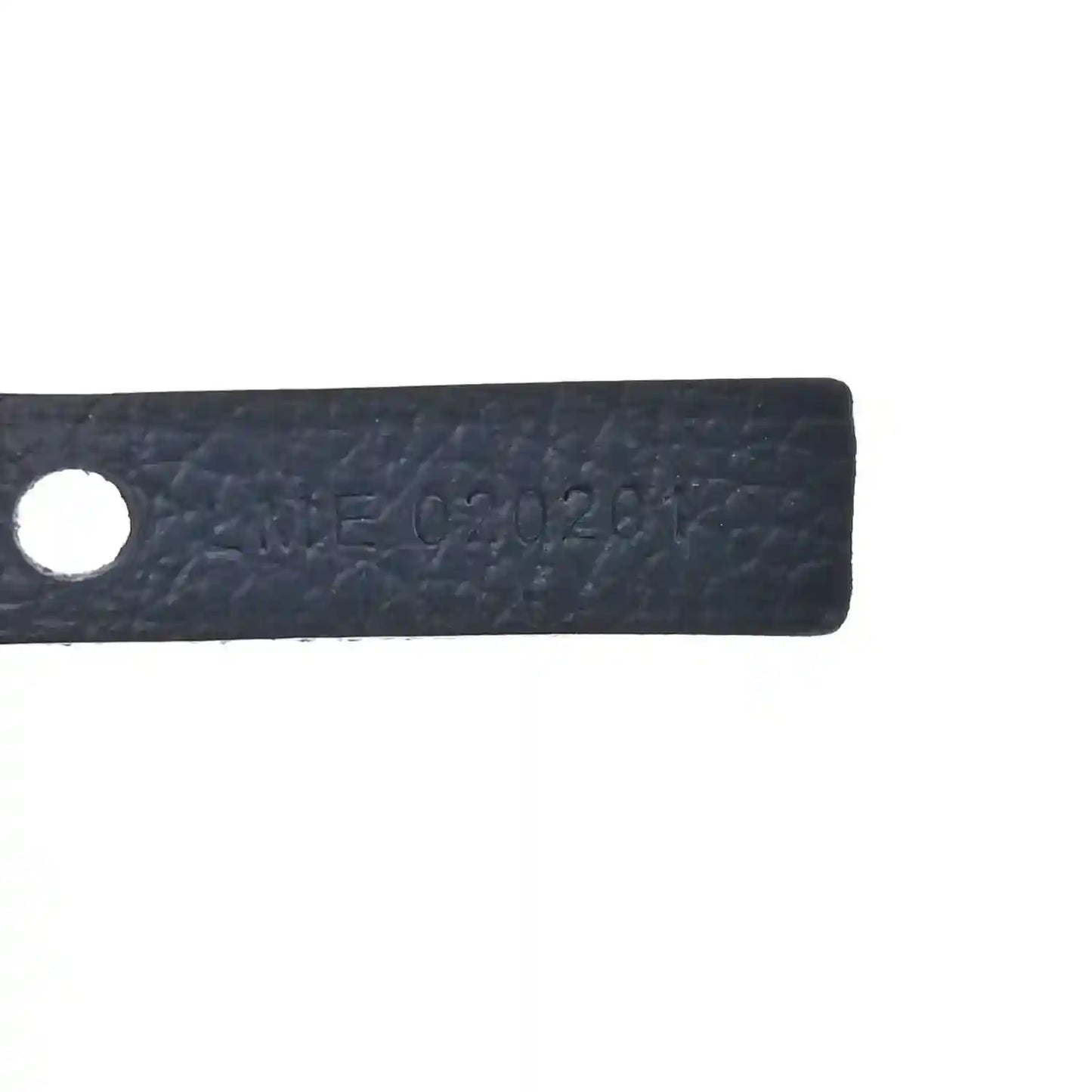 Close-up of navy leather label with stamped serial-style marking and round hole.