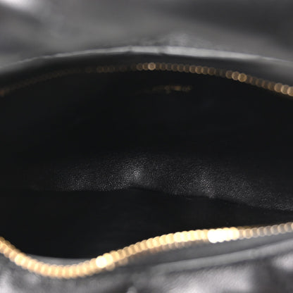 Black leather interior with gold chain trim along the top edge