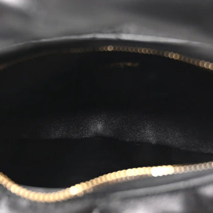 Black leather interior with gold chain trim along the top edge