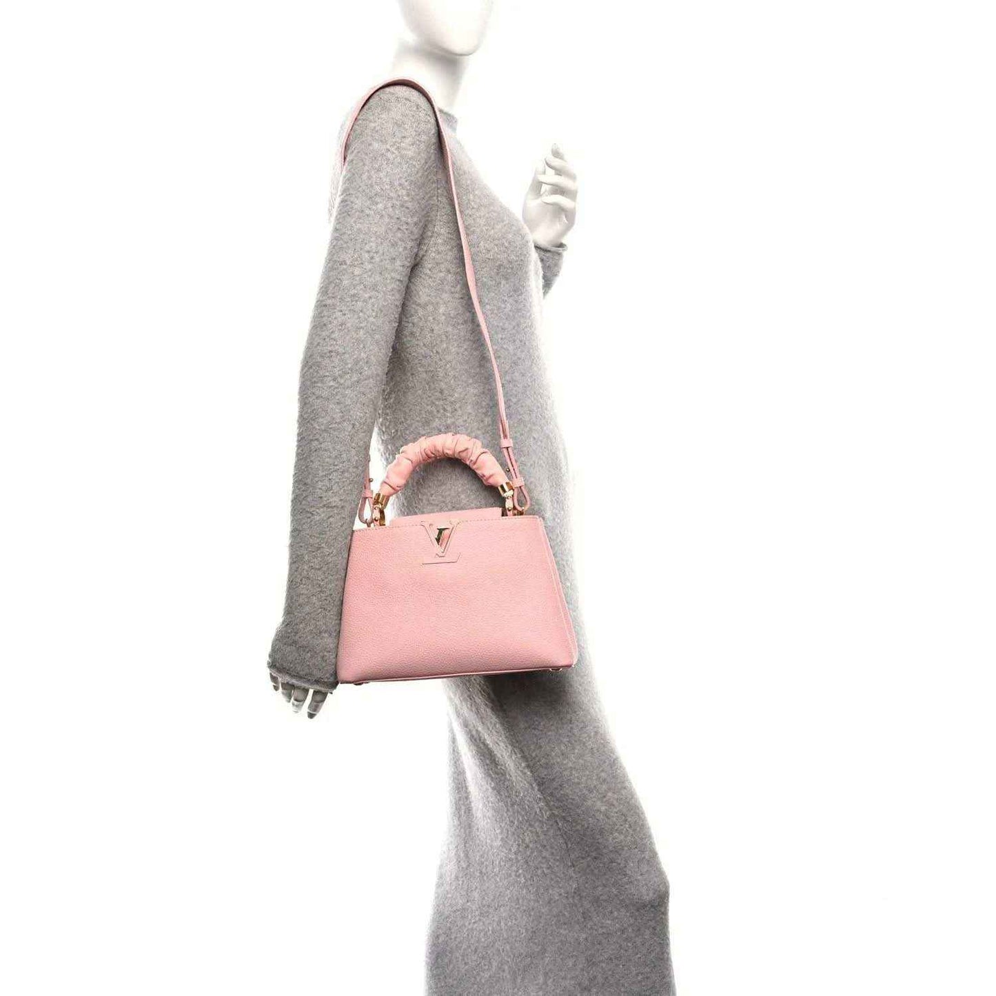 Bubble gum pink Capucines BB bag on shoulder with crossbody strap and gold hardware