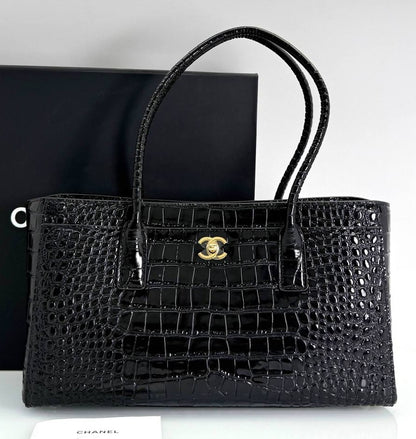 Black croc-embossed calfskin shopping tote with front logo medallion and top handles