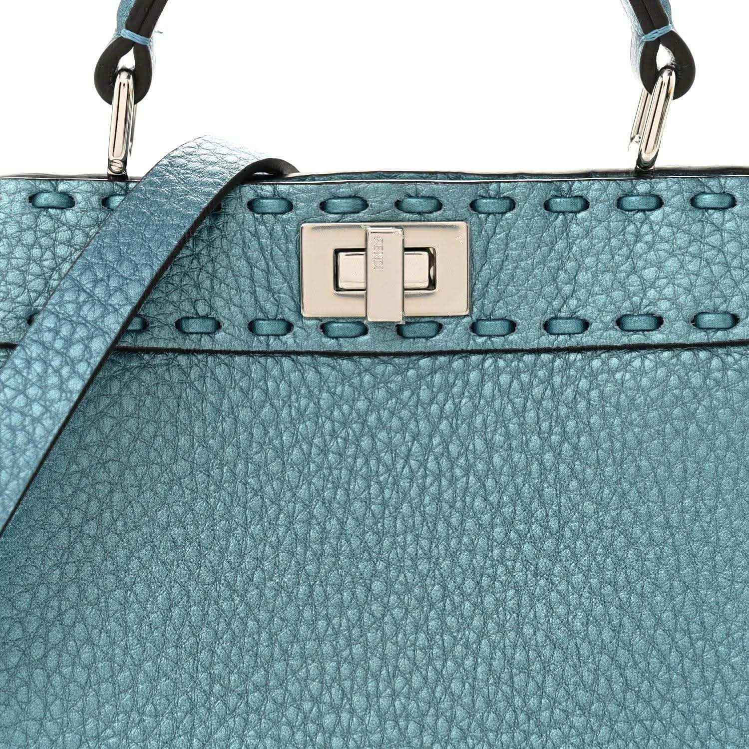 Blue pebbled leather petite satchel with front turn-lock clasp and studded trim.