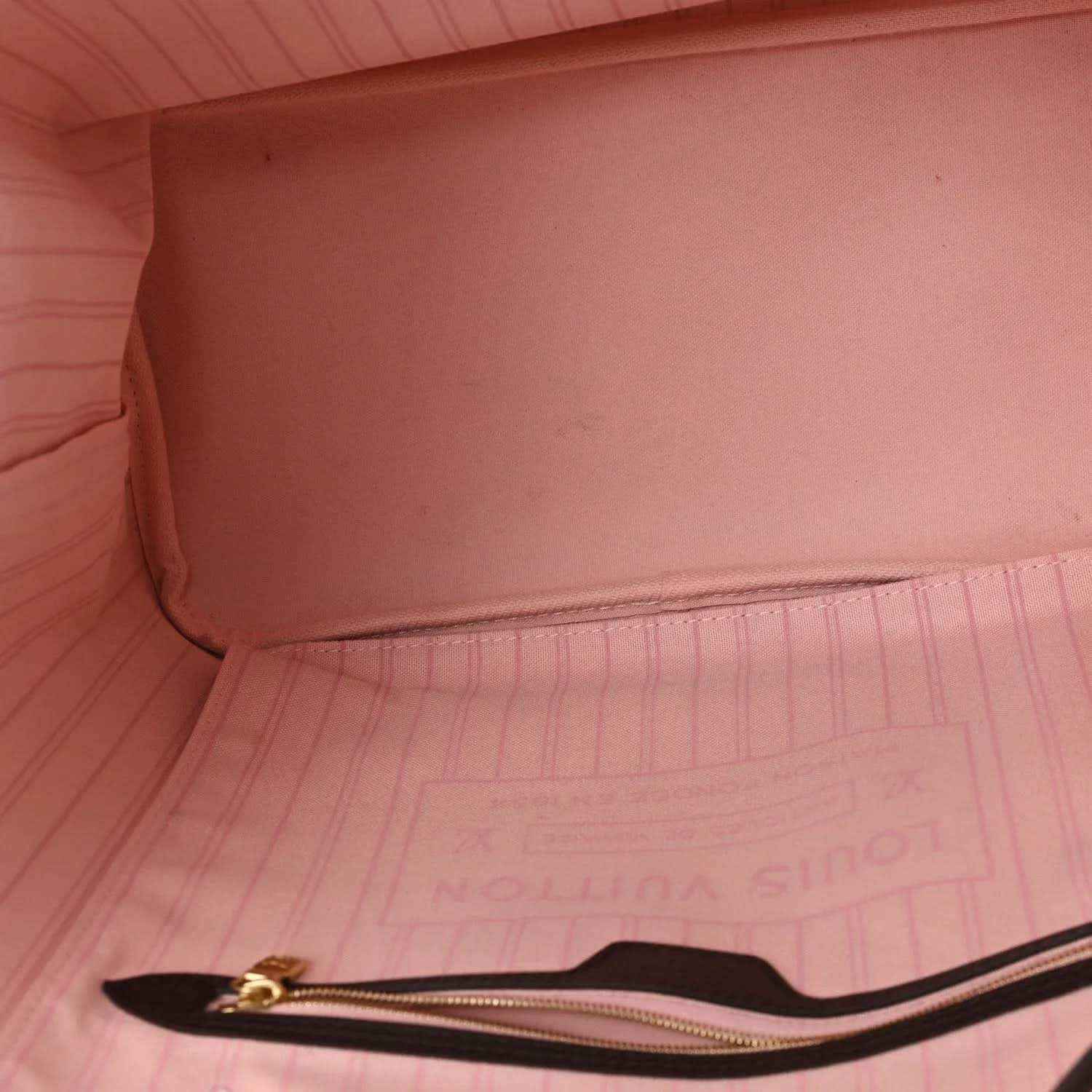 Pink interior lining and gold-tone zipper pull on Neverfull tote