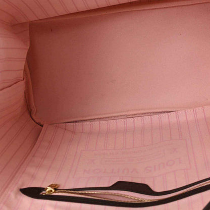 Pink interior lining and gold-tone zipper pull on Neverfull tote