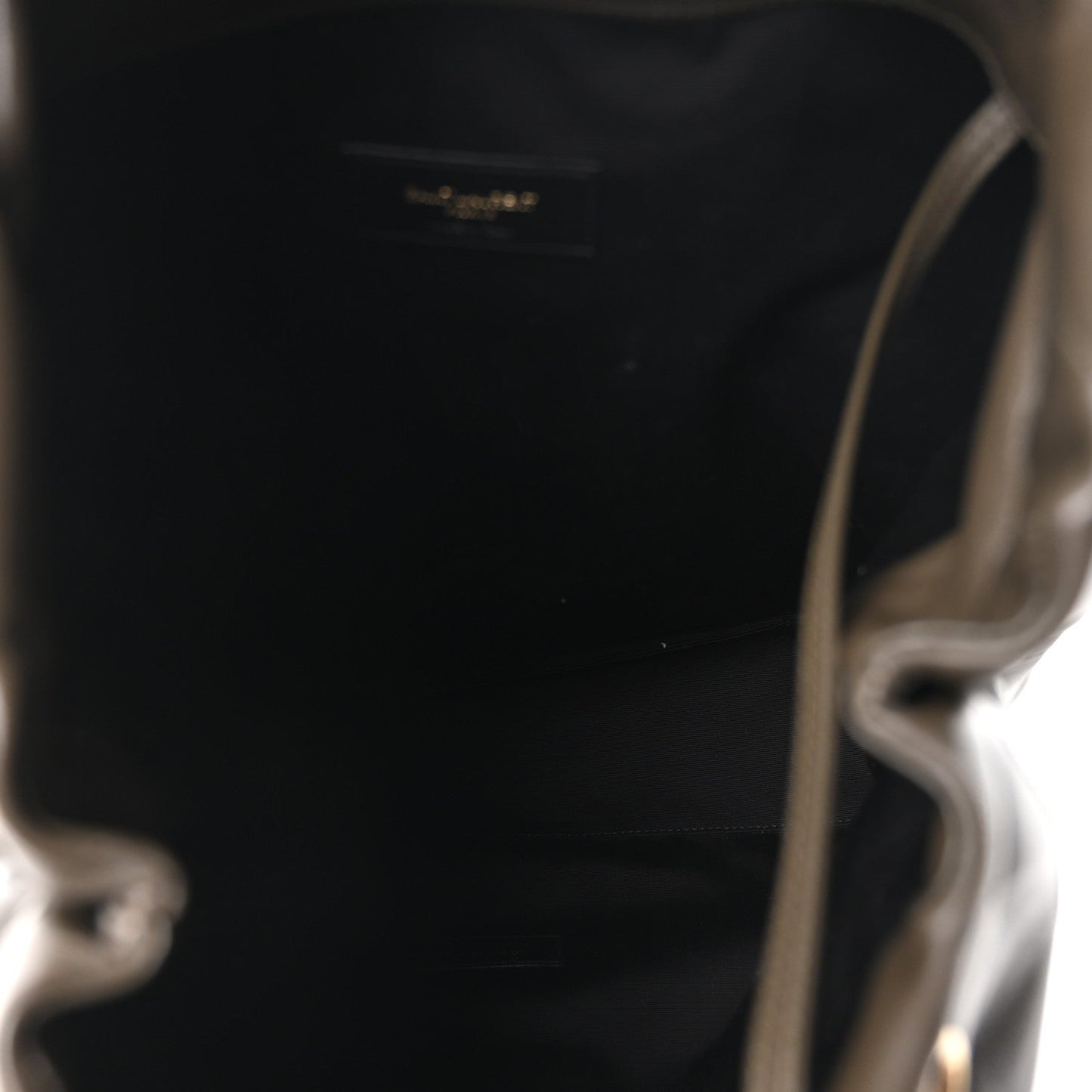 Leather shoulder bag interior view, open top with small logo patch