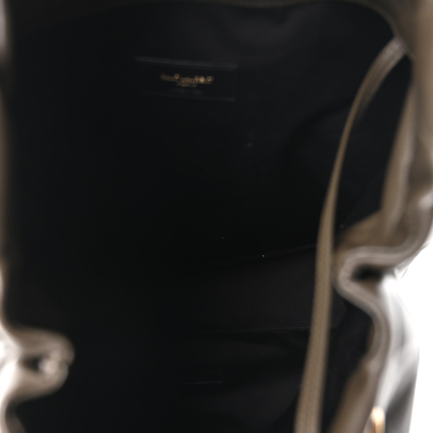 Leather shoulder bag interior view, open top with small logo patch