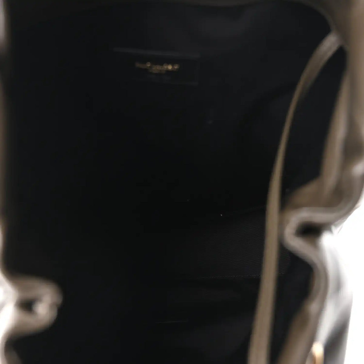 Leather shoulder bag interior view, open top with small logo patch
