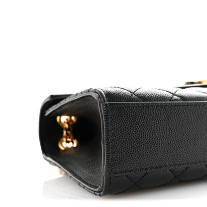 Black quilted satchel side with open corner and small gold YSL hardware detail