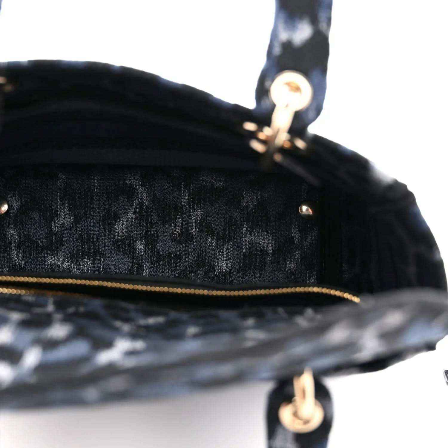 Christian Dior canvas handbag close-up of zipper track and gold hardware