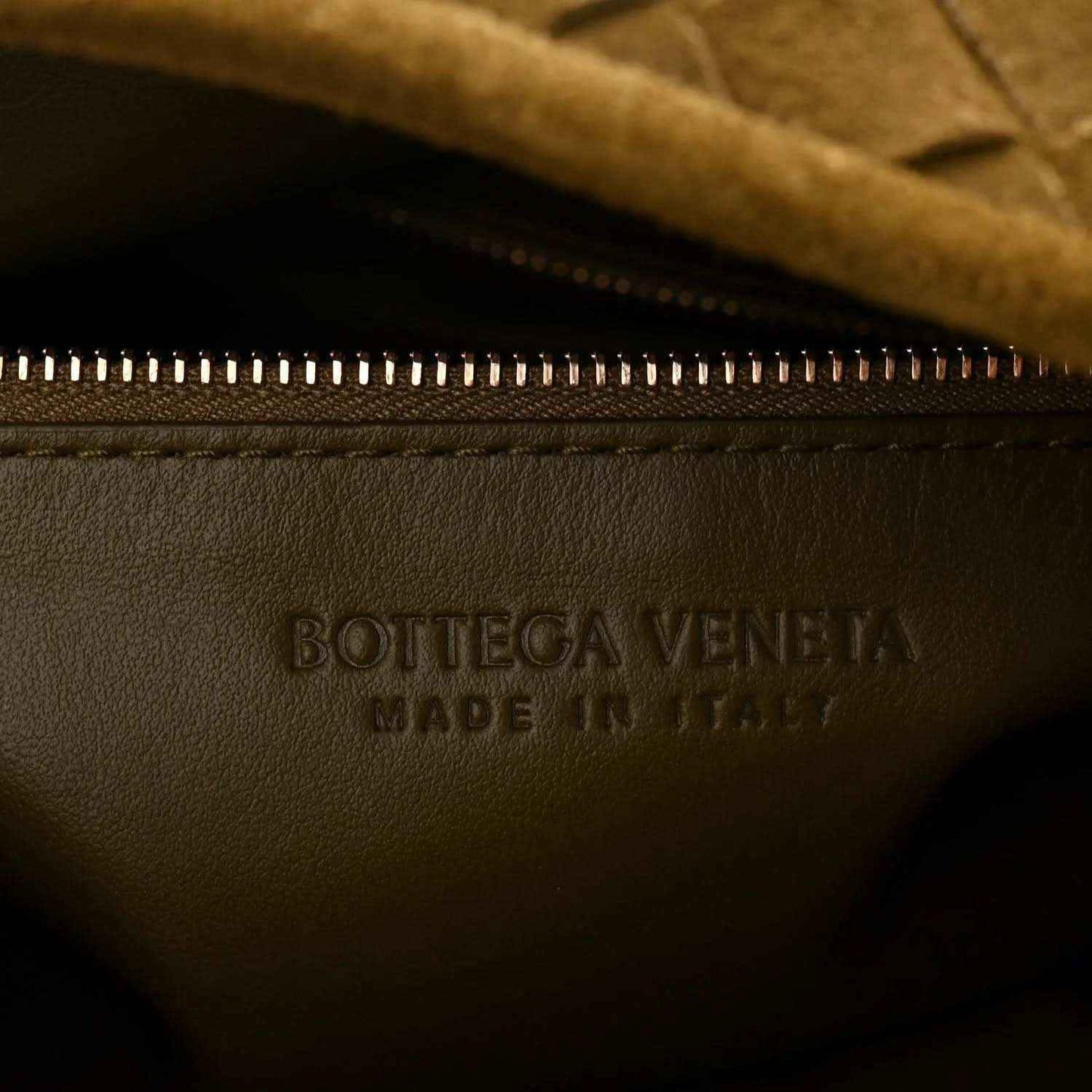 Bottega Veneta suede hobo bag, logo stamp and gold zipper close-up