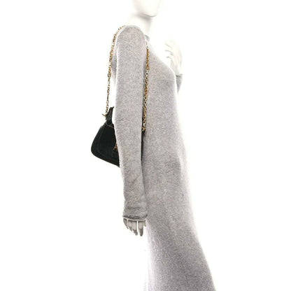 Black mini Jackie handbag with chain shoulder strap, shown from the side.