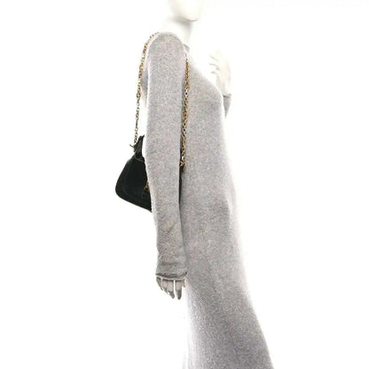 Black mini Jackie handbag with chain shoulder strap, shown from the side.