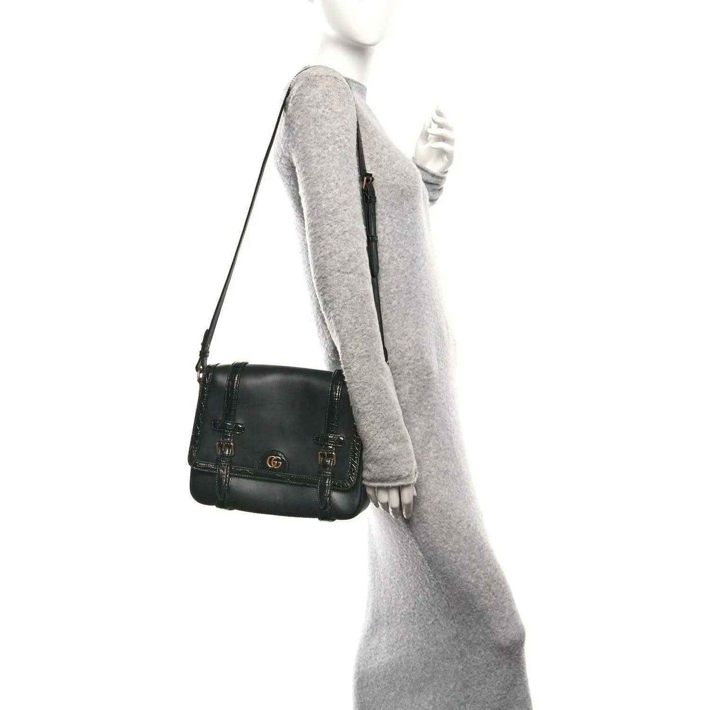 Black leather medium crossbody messenger bag with gold-toned hardware and double buckles