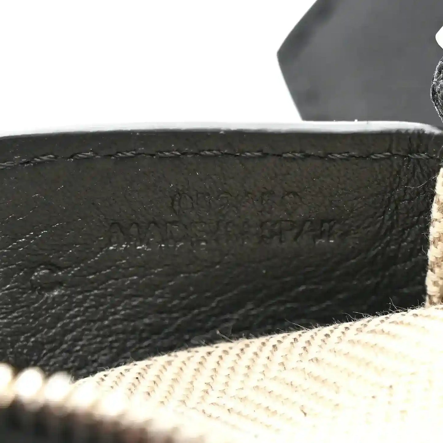 Small Puzzle Edge shoulder bag embossed logo on black leather near beige lining