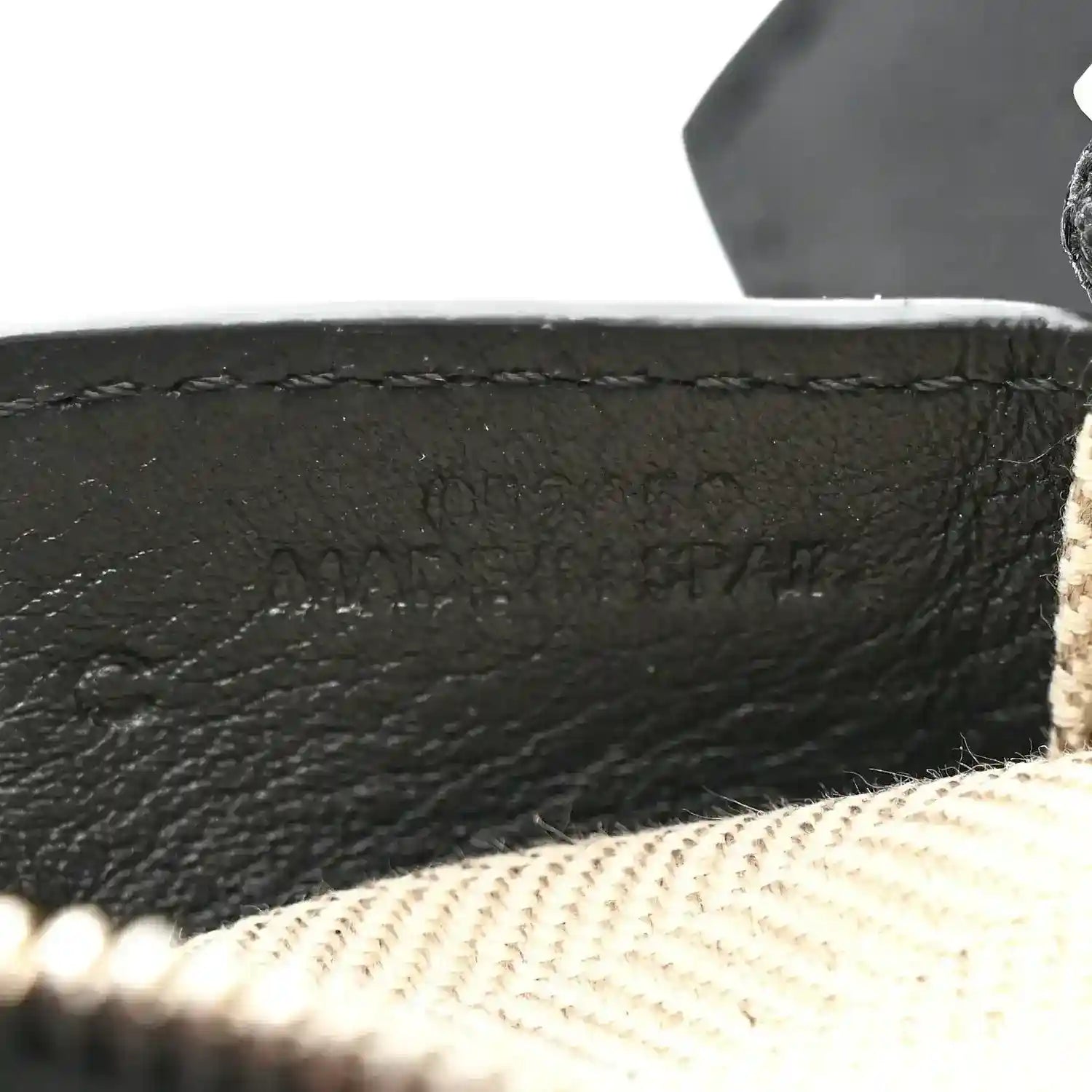 Small Puzzle Edge shoulder bag embossed logo on black leather near beige lining