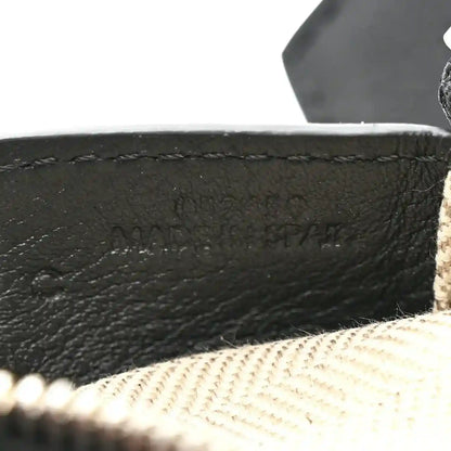 Small Puzzle Edge shoulder bag embossed logo on black leather near beige lining