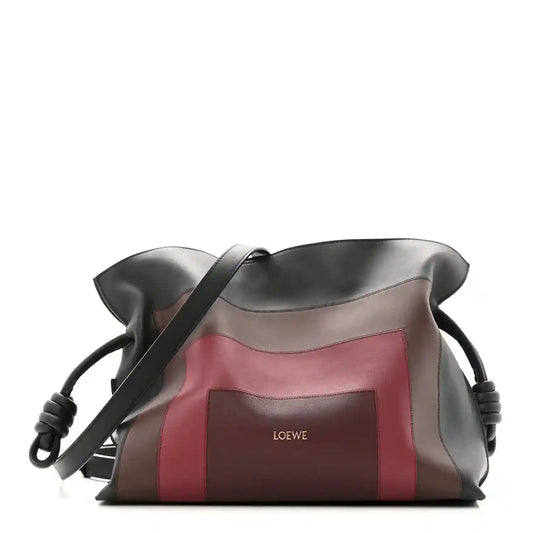 Flamenco knot calfskin clutch in black with burgundy panel and strap
