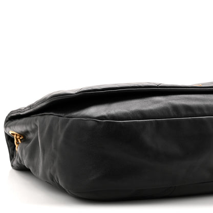 Black quilted lambskin shoulder bag close-up of top edge and rounded base