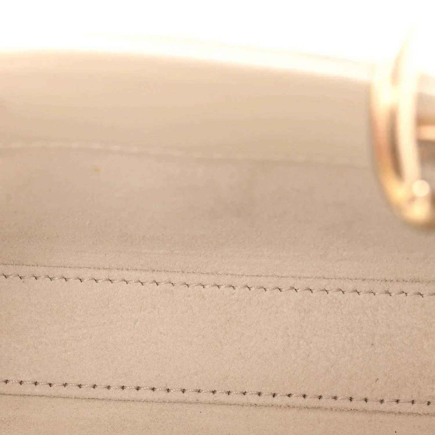 Cream lambskin bag close-up showing stitched seams