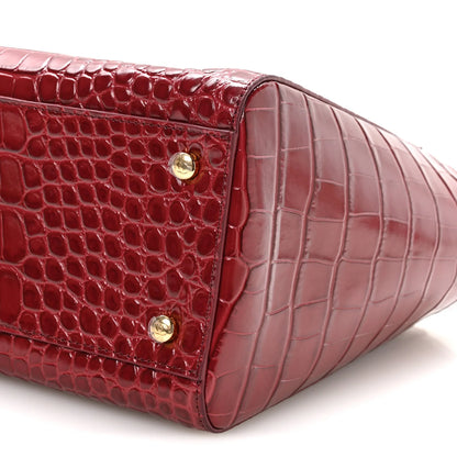 Small Chanel shopping bag side panel with croc-embossed texture and gold clasp