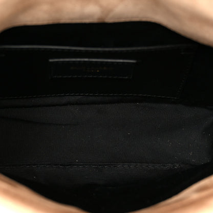 Black fabric interior of mini shoulder bag with stitched wall and top opening