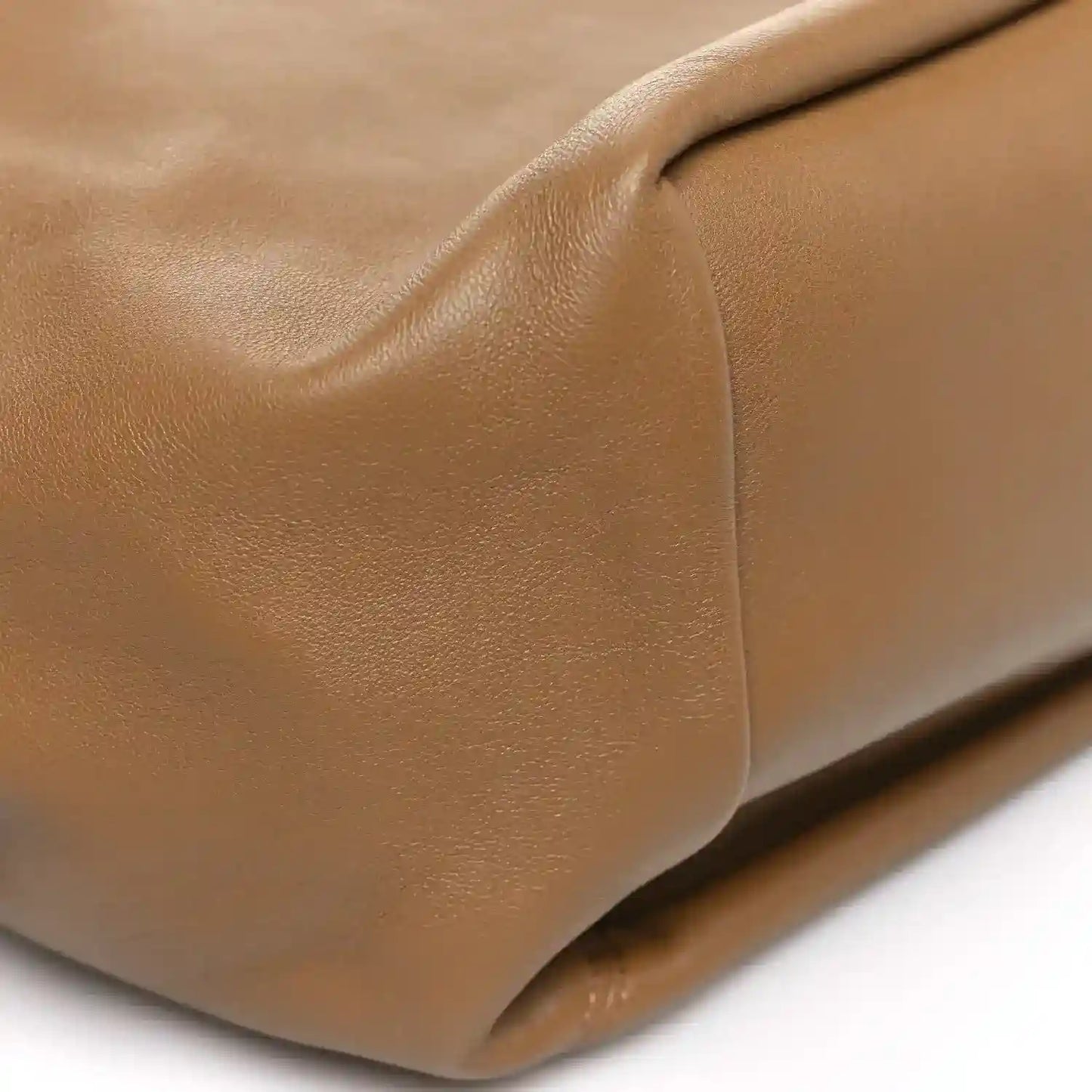 Leather bag corner detail with smooth edge piping, oak brown