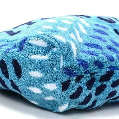 Rolled turquoise terry tote corner with black, white, and purple animal-style print.