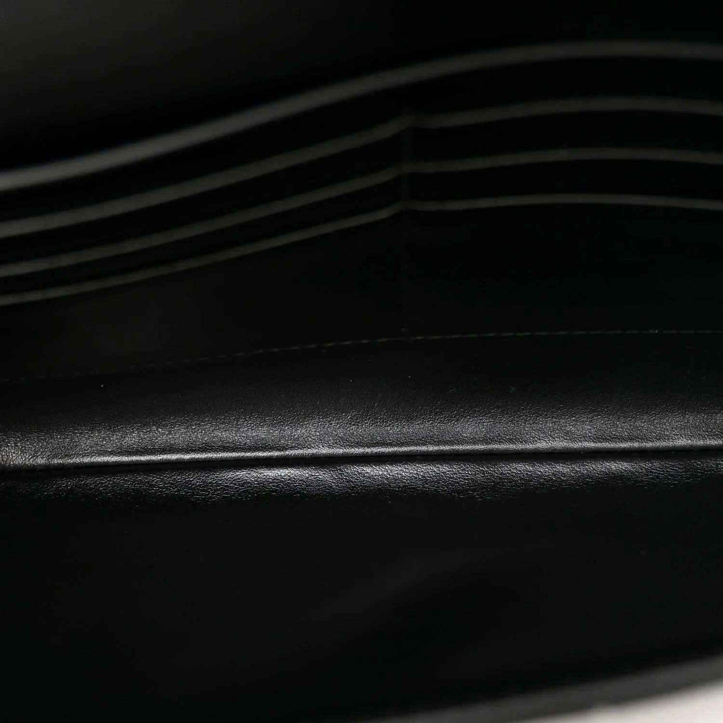 Bottega Veneta leather clutch detail, black intrecciato weave texture
