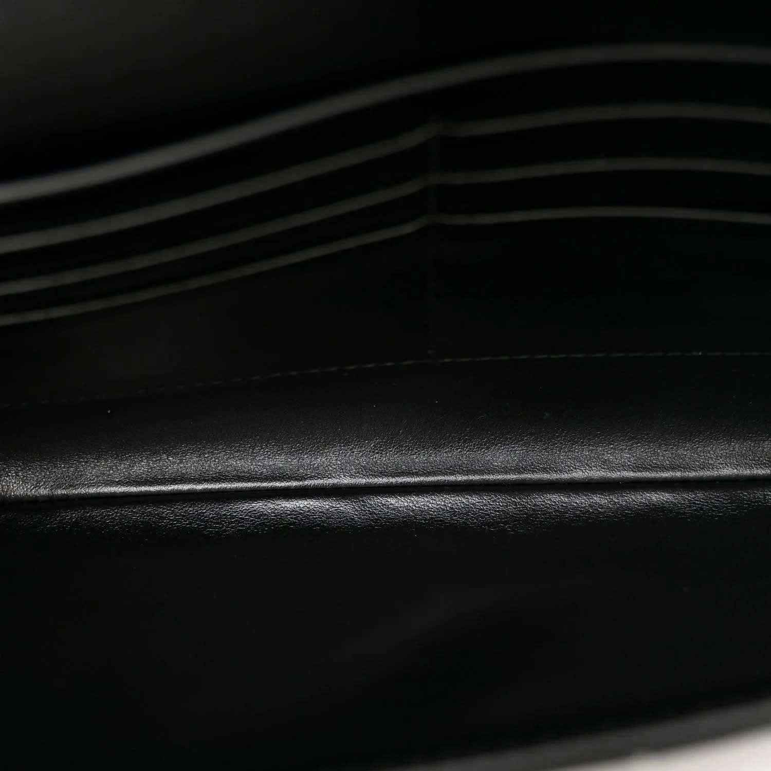 Bottega Veneta leather clutch detail, black intrecciato weave texture